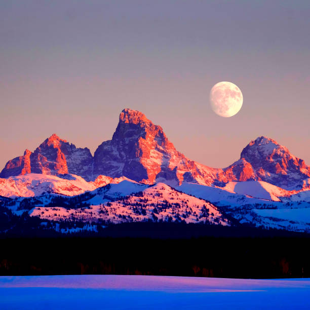 istock Sunset Light Alpen Glow on Tetons Teton Mountains wtih Moon Rising 1988227836