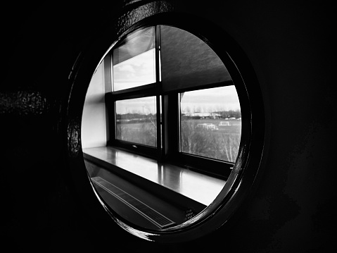 Looking through a circular window at windows