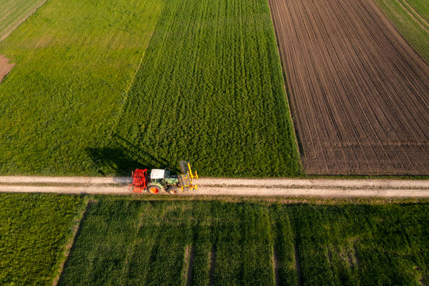 istock Tractor on dirt road, aerial view 1988232016