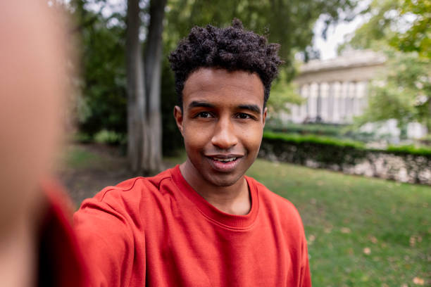 selfie of young ethnic man looking at camera smiling