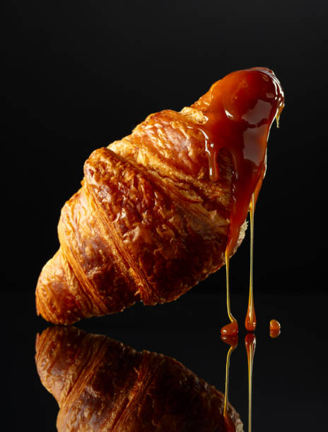 istock Fresh baked croissant with caramel sauce. 1988247196