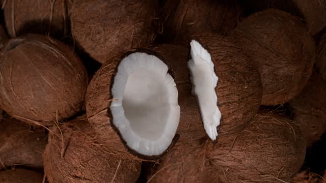 Cracked coconut falling, super slow motion
