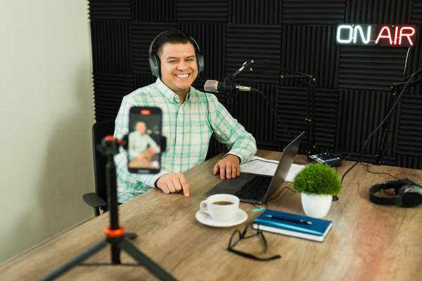 istock Excited podcast host live streaming while recording an episode 1988302534