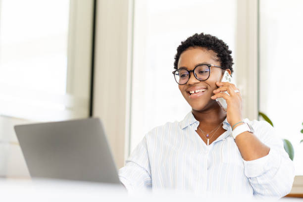 istock African-American female office employee using laptop 1988306821