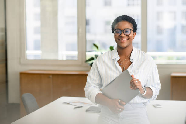 istock African-American female office employee using laptop 1988306822