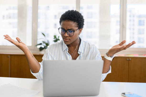 istock African-American female office employee using laptop 1988306829