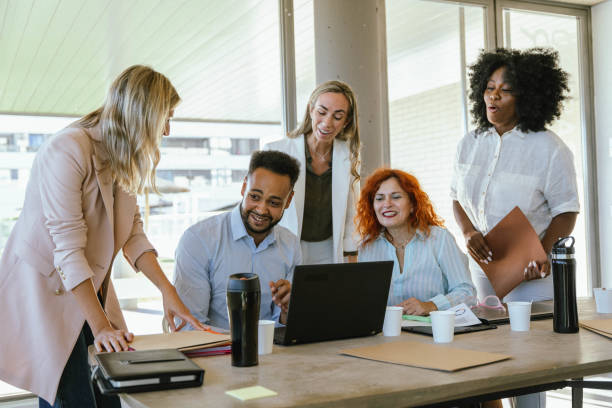 istock Group of multiethnic business people smiling while working together in the office. 1988322268