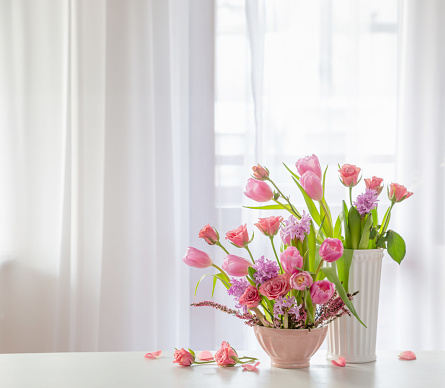 Beautiful pink tulips in a vase. Home interior photo stock photo.