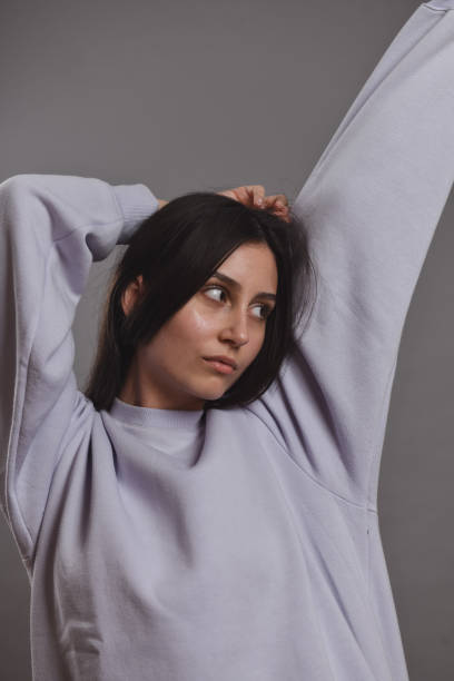 istock Female Stretching Out Sleepily In Her Oversized Lilac Sweater 1988336899