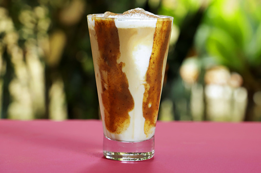 A glass of creamy coffee drink with dulce de leche