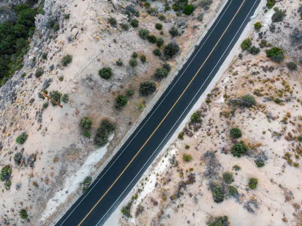 Paved desert road blacktop with no cars as viewed from above