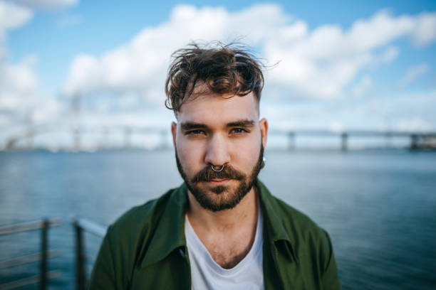 Portrait of young man with nose ring.