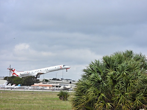 Boca Raton, Palm Beach County, Florida, USA, Jan 15, 2024. An Embraer fixed wing multi engine (55 seats / 2 engines)
N959JX taking off from the Boca Raton Airport.