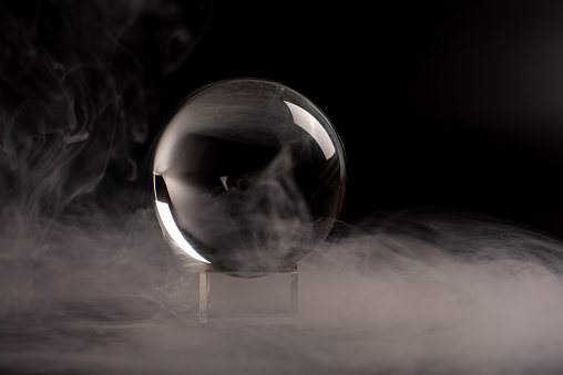 crystal ball, beautiful crystal ball with smoke on black background, selective focus.