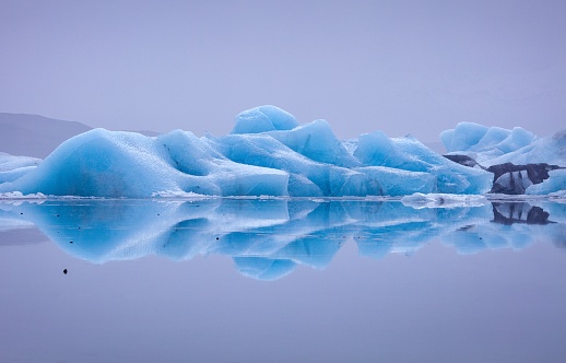 Icebergs reflected in a glacial lake - Iceland