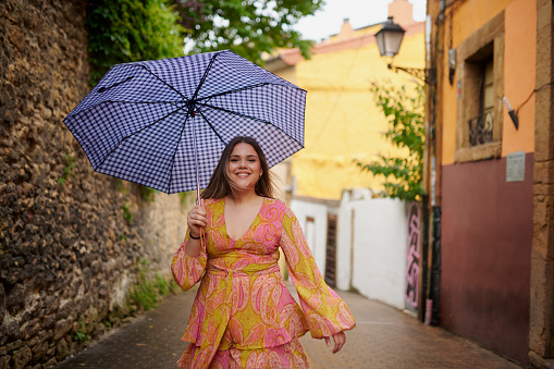 Travel, portrait and happy woman with umbrella in a city street for walking, explore or adventure in Italy. Freedom, cover and female person outdoor in Venice for holiday, journey or solo vacation