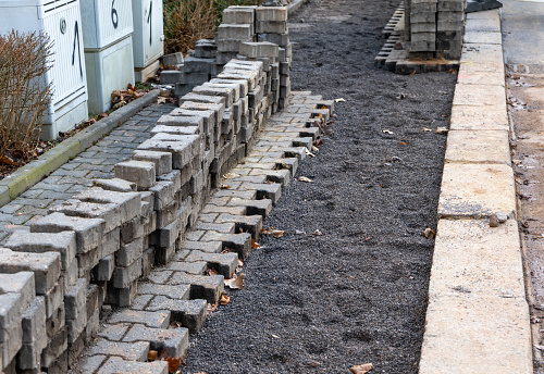 Paving stones are being renovated on a footpath in the city