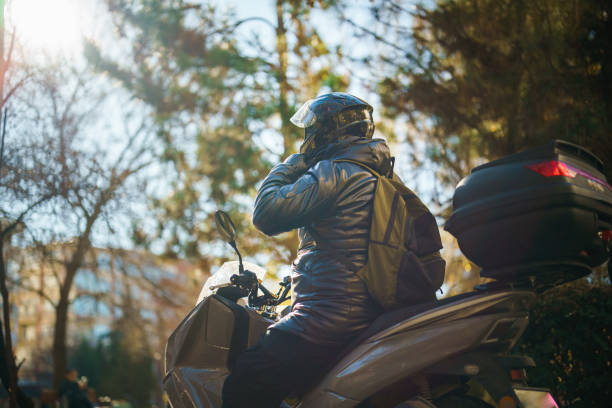 Man with his motorbike in streets