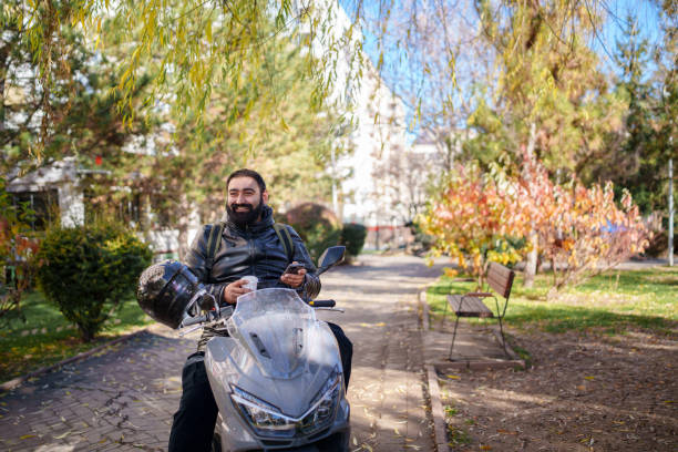 Man with his motorbike in streets