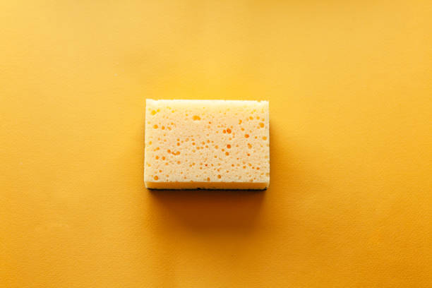istock peach color color sponge, home cleaning concept 1988531824