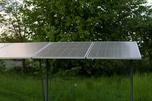 istock vertical image Solar panels installed on a green area among plants to supply light. eco technology concept, green planet, earth day 1988532856