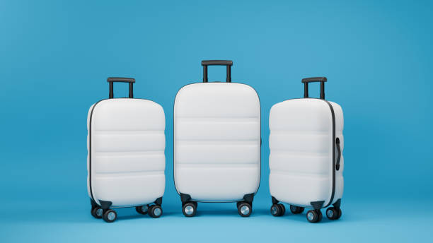 istock Three white traveling suitcases on blue background. Large and small cases with luggage. 3D rendering. 1988580054