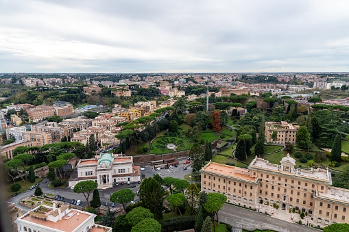 Roma, Latium - Italy - 11-26-2022: Overhead shot capturing the lush Vatican Gardens surrounded by Rome's urban sprawl, showcasing a blend of nature and city