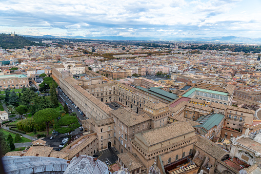 Roma, Latium - Italy - 11-26-2022: Aerial perspective of Vatican City's historic architecture with Vatican Museums and surrounded by Rome's sprawling urban landscape