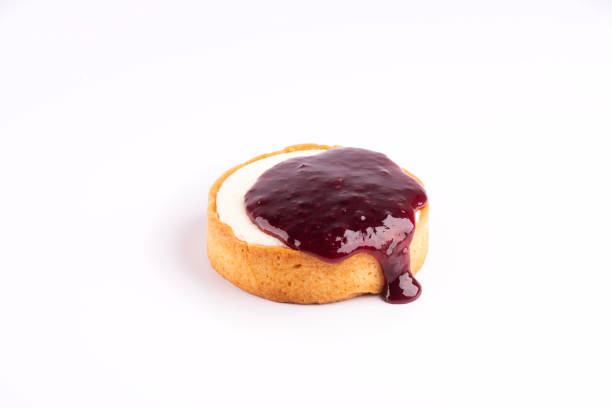 istock cheese cake with pouring dripping berry jam isolated on white background 1988612411