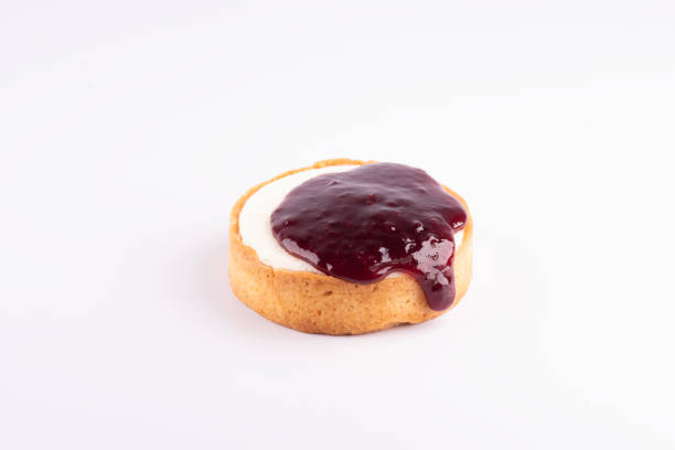 istock cheese cake with spilling berry jam isolated on white background 1988612717