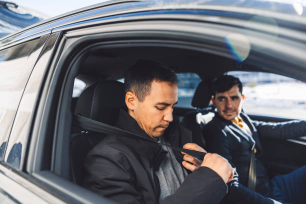 istock Driver transporting a business man on a crowd sourced taxi 1988673513