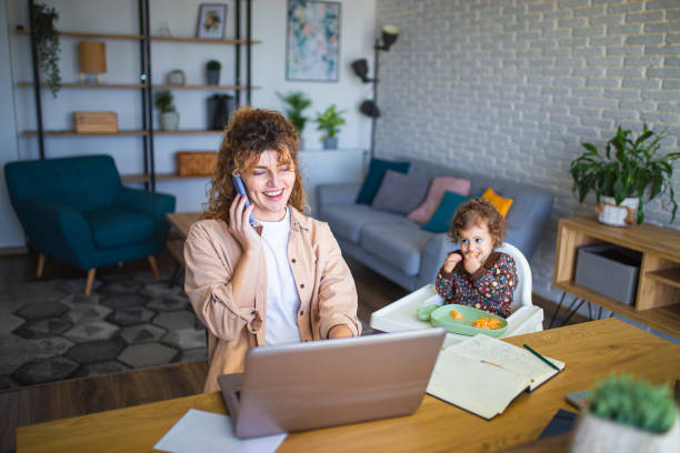 istock Young mother working from home while taking care of her baby 1988682044