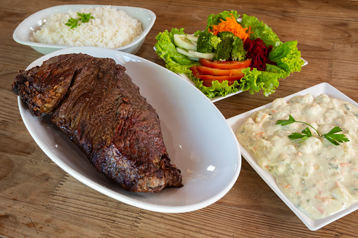 Brazilian beef barbecue with complements - Salad, vegetable mayonnaise, rice and fries