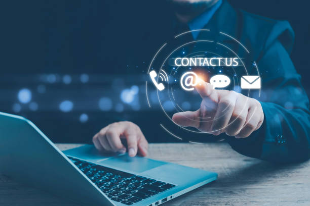 istock Contact us or Customer support hotline, people connect. Businessman touching on virtual screen contact icons (email, address, live chat, telephone). Customer service, helpdesk advice online support. 1988746300