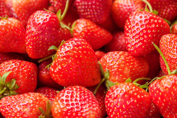 istock Fresh organic red strawberry fruit background 1988795052