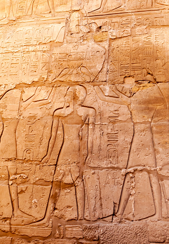 Luxor, Egypt - March 01, 2019: ancient Egyptian hieroglyphs, drawings and inscriptions on the walls and columns in the temple of Karnak in Luxor