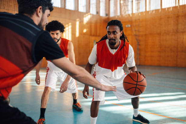 istock Interracial basketball player is dribbling a ball on training. 1988812131