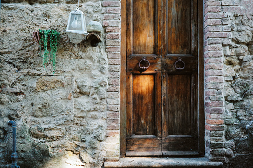 Rustic brown wooden door somewhere in Tuscany
