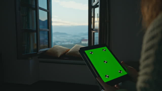 SLO MO Closeup of Woman Holding Digital Tablet with Green Screen Chroma Key near Open Window in Apartment