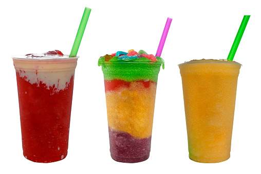 Panoramic still life of colorful frozen fruit granita drinks flowing in plastic takeaway cups with ice cream straws taste