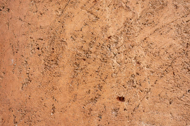 istock Full frame shot of an earthen wall texture of clay house structure. 1988844525