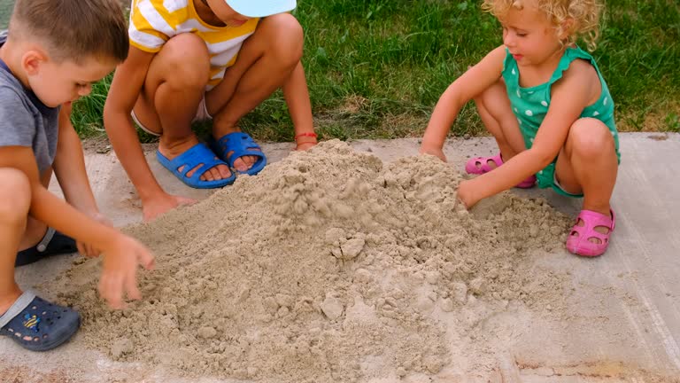 child plays in the sandbox. Selective focus. people.