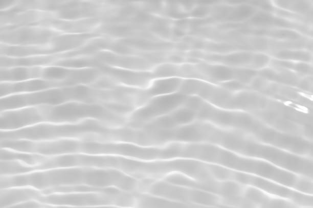 istock Water surface. Bluewater waves on the surface ripples blurred. Defocus blurred transparent blue colored clear calm water surface texture with splash and bubbles. Water waves with shining pattern. 1988920229
