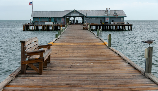 Florida, USA - November  28, 2011: wooden pier with a restaurant on the shore in the Gulf of Mexico, Florida