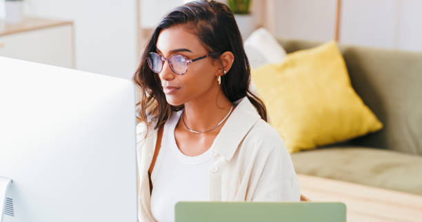 istock Business woman, computer and work from home planning, reading and editing online for remote copywriting career. Young editor, writer or freelancer with glasses and desktop for social media research 1988921675