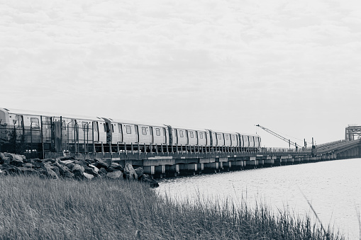 View of A train crossing the bridge over Jamaica Bay in the Queens, New York. Subway in NY outside