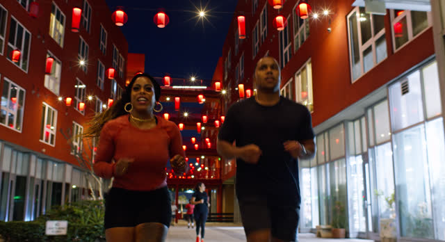 African American Couple Leading the Charge in a Night Jog in Los Angeles, California