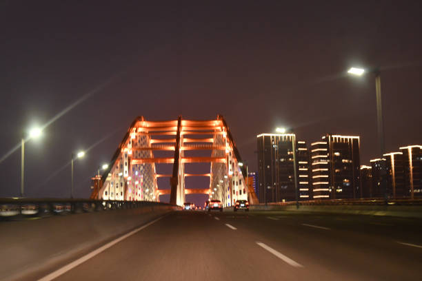 speedy drive toward bridge on highway at night