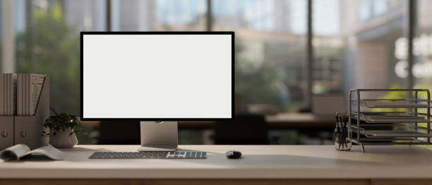 istock A computer mockup with a white screen and office supplies are arranged on a table in a modern office 1988994994