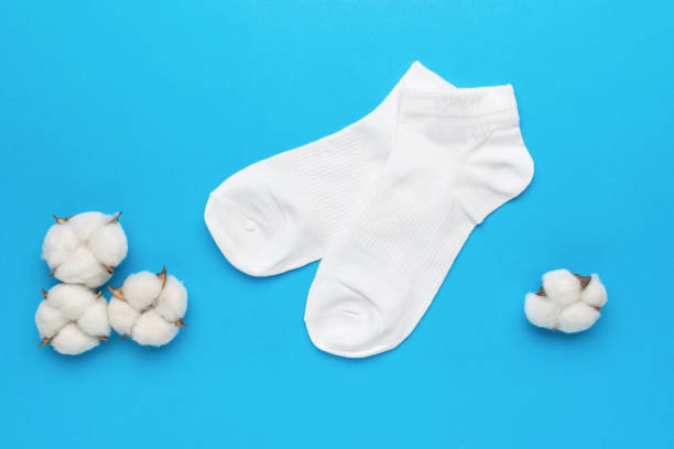 istock Cotton buds and a pair of white socks on a blue background. 1989025422